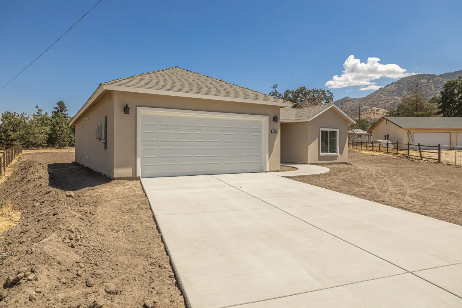 Sunset Retreat model exterior with the Tehachapi mountains behind it